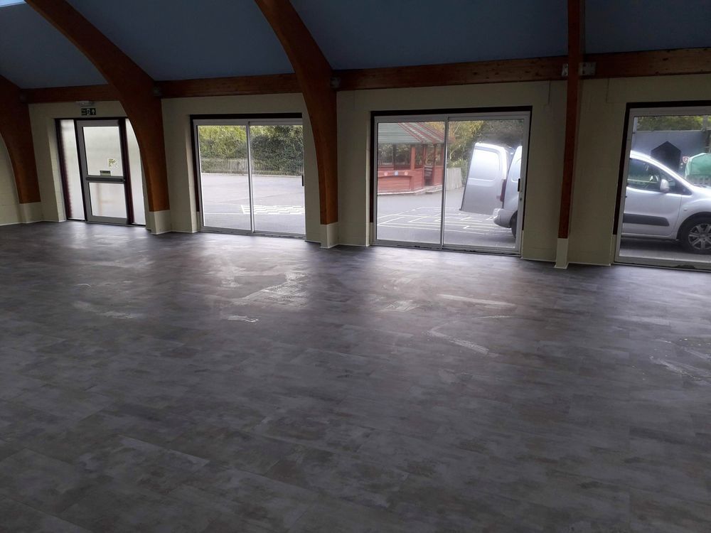 Modern grey LVT flooring professionally laid in a large open-plan room in Essex by Holmes Interior Flooring