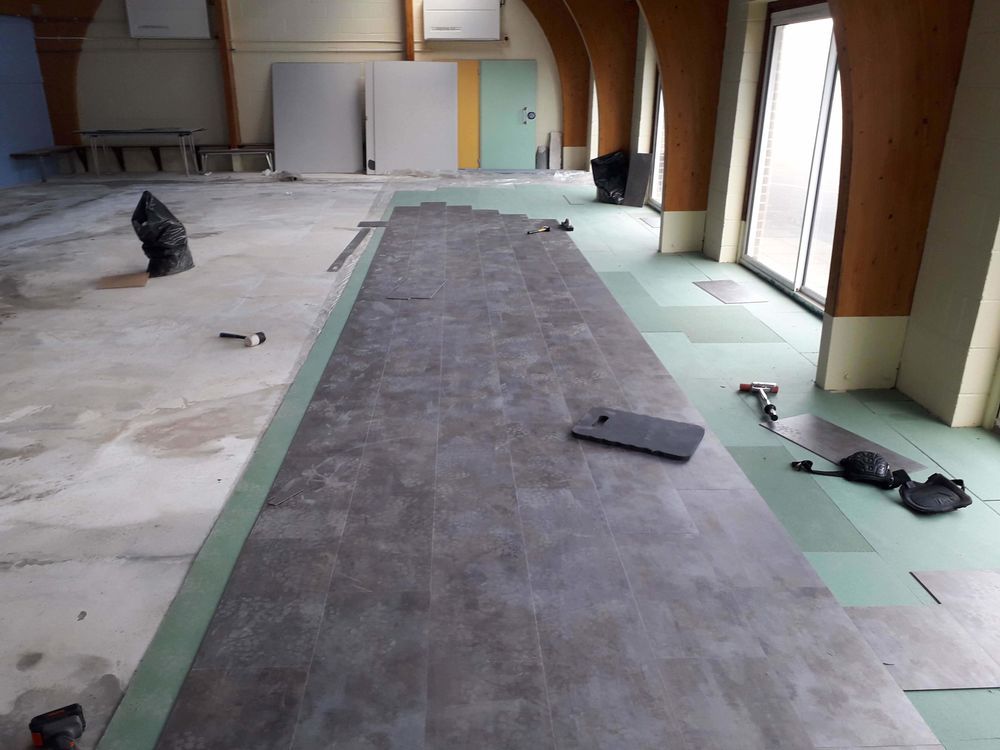 LVT planks being installed in a large room in Essex
