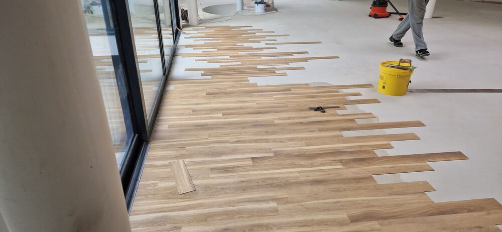 Light oak wood floor being laid near patio doors in Essex